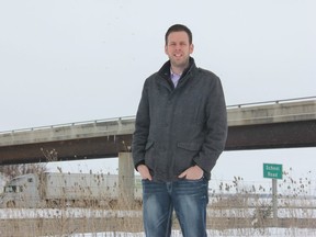 Adelaide Metcalfe Mayor Kurtis Smith stands near the School Road overpass at Highway 402. Smith wants the province to install electronic boards along the highway as a way to keep drivers informed of weather conditions and major accidents. (JONATHAN JUHA/POSTMEDIA NEWS)