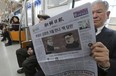 A passenger reads a newspaper with a headline of a planned summit meeting between North Korean leader Kim Jong-un and U.S. President Donald Trump on a subway in Seoul, South Korea, last week. Ahn Young-joon/AP Photo