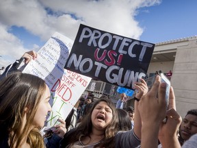 Maria Ramirez, center, protests along with hundreds of other Silverado students in the senior quad at the Victorville, Calif., high school on Wednesday March 14, 2018. The students were joining a nationwide 17 minute walk out to advocate for better gun control and school safety. (James Quigg/The Daily Press via AP)