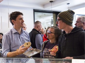 Prime Minister Justin Trudeau talks with the owners of Donut Monster, a business located on Locke Street in Hamilton, this week.
