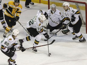 London Knights' Alec Regula redirects the puck away from goaltender Jordan Kody, with teammates Alex Formenton, Evan Bouchard with Kingston Frontenacs'  Jakob Brahaney giving chase during the first period of Ontario Hockey League action at the Rogers K-Rock Centre in Kingston, Ont. on Friday, March 2, 2018. (JULIA MCKAY/Postmedia Network)