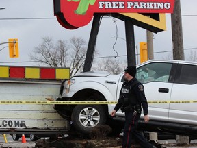 Police arrested a man after a stolen pickup truck slammed into a sign outside Under the Volcano, a Mexican restaurant at 30 Wharncliffe Rd., just south of Riverside Drive, around 11:30 a.m. Wednesday. (DALE CARRUTHERS / THE LONDON FREE PRESS)