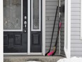 A hockey stick sits on the front porch of a house in Humboldt, Sask., on Monday. Canadians, including Londoners, are reaching out to Humboldt by leaving hockey sticks on front porches to pay tribute to the 16 lives lost after a bus carrying the Broncos junior hockey team collided with a tractor trailer. (Jonathan Hayward/The Canadian Press)