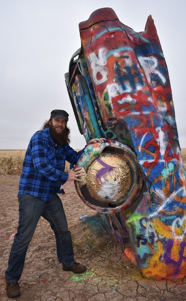 Mike from Milwaukee, Wisc.  takes a break from a road trip to Los Angeles to check out the 10 half-buried Caddies at Cadillac Ranch, outside Amaraillo, Texas. Mike spray-painted his name on the quirky installation about 10 years earlier.

BARBARA TAYLOR/The London Free Press/Postmedia News