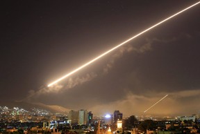 Damascus skies erupt with surface-to-air missile fire as the U.S. launches an attack on Syria on April 14. (Hassan Ammar/AP Photo)