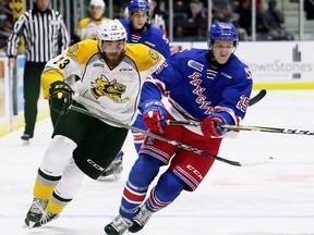 FILE PHOTO: Sarnia Sting's Curtis Egert, left, and Kitchener Rangers' Alex Peterson chase the puck in the first period at Progressive Auto Sales Arena in Sarnia, Ont., on Saturday, Sept. 23, 2017. (Mark Malone/Postmedia Network)