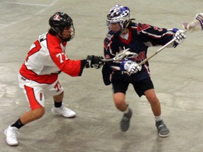 Isaac Doxtator with the Point Edward Jr. B Pacers guards against Quincy Abram of the London Blue Devils during an exhibition lacrosse game in April at the Point Edward Arena. (Handout, Point Edward Pacers)