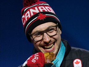 London's Alexander Kopacz poses on the podium after winning gold at the 2018 Winter Olympics. (AFP)