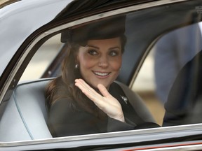 Britain's Catherine, Duchess of Cambridge waves from a car as she leaves after attending the Easter Mattins Service at St. George's Chapel, Windsor Castle on April 1, 2018.