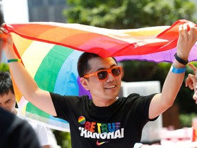 A man holding a rainbow flag after taking part in the Pride Run in Shanghai in June 2017.  China's gay community scored a victory when Twitter-like Weibo reversed a ban on "homosexual" content, but it still faces challenges in a country where LGBT culture remains taboo in the entertainment industry. (AFP/Getty Images)