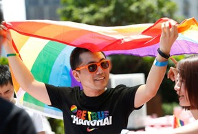 A man holding a rainbow flag after taking part in the Pride Run in Shanghai in June 2017.  China's gay community scored a victory when Twitter-like Weibo reversed a ban on "homosexual" content, but it still faces challenges in a country where LGBT culture remains taboo in the entertainment industry. (AFP/Getty Images)