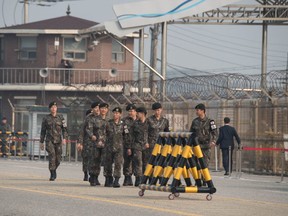 South Korean soldiers walk on Tongil bridge before a checkpoint as they wait for the convoy carrying South Korean president Moon Jae-in, leading to the Demilitarized Zone (DMZ) and truce village of Panmunjom, in Paju on April 27, 2018. North Korea's leader Kim Jong Un and the South's president Moon Jae-in will meet at the Military Demarcation Line that divides the peninsula before their summit Friday, Seoul said, in an occasion laden with symbolism.  / AFP PHOTO / Ed JONESED JONES/AFP/Getty Images