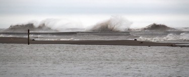 Lake Erie waves crash over the pier in Erieau, Ont. on Sunday. Ellwood Shreve/Chatham Daily News/Postmedia Network