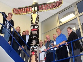 These Tecumseh Secondary School grads are among those who support keeping the totem pole, created by four students in the early 1970s, a part of the Chatham school. Photo taken in Chatham, Ont. on Monday April 16, 2018. (Ellwood Shreve/Postmedia Network)