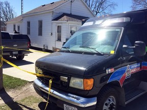 Chatham-Kent police investigate at a Book Street home in Wallaceburg Friday. Kourtny Audette, 25, is charged with first-degree murder in the death of a man.  (DAVID GOUGH, Postmedia News)