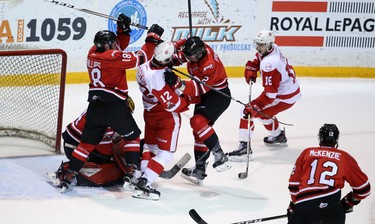 Attack defenders Markus Phillips and Jacob Friend work over Boris Katchouk in front of Olivier Lafreniere as the goaltender freezes the puck in the first period of Game 4 between Owen Sound and Sault Ste. Marie at the Harry Lumley Bayshore Community Centre in Owen Sound. Greg Cowan/The Sun Times