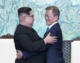 North Korean leader Kim Jong Un, left, and South Korean President Moon Jae-in embrace each other after signing on a joint statement at the border village of Panmunjom in the Demilitarized Zone, South Korea, Friday, April 27, 2018.