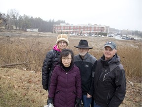 Victoria Digby, left, Chao Zhang, Tony Furlong and Peter Newson are unhappy about plans to build a highrise at the northeast corner of Richmond Street and North Centre Road in London. (DEREK RUTTAN, The London Free Press)