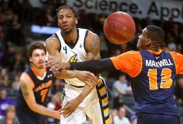 Marcus Capers of the London Lightning passes out to the wing as he's guarded under the hoop by Du'Vaughan Maxwell of the Island Storm.
Mike Hensen/The London Free Press