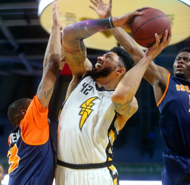 Julian Boyd of the London Lightning draws in two Island Storm defenders Du'Vaughan Maxwell and Kemy Osse before being fouled. 
Mike Hensen/The London Free Press