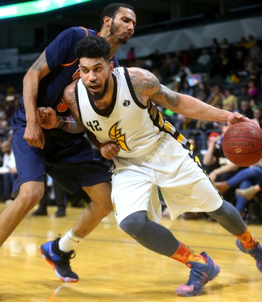 Julian Boyd of the London Lightning drives into Trenity Burdine of the Island Storm. The Lightning went on to beat the Storm 140-136 at Budweiser Gardens Sunday.
Mike Hensen/The London Free Press