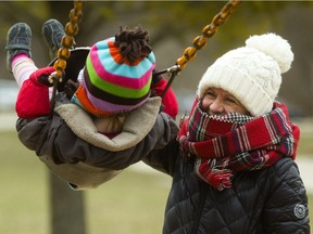 Victoria Andersen is bundled up for April's cool start as she pushes her granddaughter Lily, 2, on a swing in Gibbons Park Tuesday in London. Andersen and her husband Bjarne have Lily and her sister Grace, 3, every Tuesday to play. Andersen said, "I was determined to go to the park, so we just had to wear enough clothes." (MIKE HENSEN, The London Free Press)