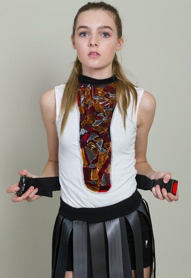 Lara Ross, 13 of Ryerson elementary school, wears a creation made of seat belts and broken glass by Jillian Crow and Nicholas Cinjau, students in Fanshawe College's design foundations and fashion marketing and management program. 
Mike Hensen/The London Free Press