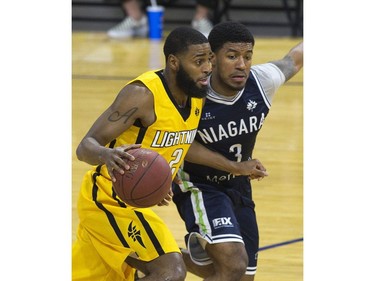 The London Lightning's Ashton Smith dribbles past Ronnie Johnson of  the Niagara River Lions during a 151-115 win over the Niagara River Lions in Game 1 of their best-of-five National Basketball League of Canada quarterfinal at Budweiser Gardens Friday. 
Derek Ruttan/The London Free Press