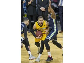 The London Lightning's Garrett Williamson powers through Guillaume Payen Boucard and Kris Joseph of the Niagara River Lions in Game 1 of their best-of-five National Basketball League of Canada quarterfinal at Budweiser Gardens Friday. The Lightning won 151-115. 
Derek Ruttan/The London Free Press