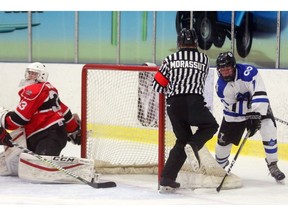 Luke Drewitt of London Nationals, has Listowel Cyclones goalie Max Wright out of position on a wrap around but for a ill-placed skate belonging to referee Jake Morassut during the first period Sutherland Cup semifinal at the Western Fair Sports Centre in London. The Nationals led 2-0 in the first period. Photograph taken on Wednesday April 11, 2018.  Mike Hensen/The London Free Press/Postmedia Network