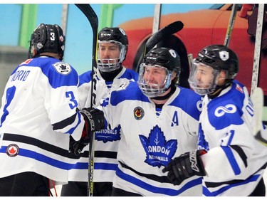 Brandon Glover of the Nationals centre, celebrates his goal with #3 Derek Di Iorio, captain Brenden Trottier and Jordan Di Cicco in the first period of their playoff game against the Listowel Cyclones at the Western Fair Sports Centre on Sunday.  Mike Hensen/The London Free Press/Postmedia Network