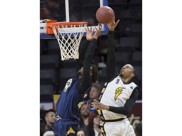 Doug Herring Jr. of the London Lightning smacks the ball away from St. John's Edge shooter Charles Hinkle during Game 1 of their National Basketball League of Canada best-of-seven Central Division final Tuesday at Budweiser Gardens. Derek Ruttan/The London Free Press