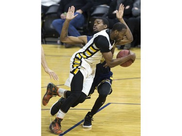 Xavier Ford of the St. John's Edge is run over by Doug Herring Jr. of the London Lightning during Game 1 of their National Basketball League of Canada best-of-seven Central Division final Tuesday at Budweiser Gardens. Derek Ruttan/The London Free Press