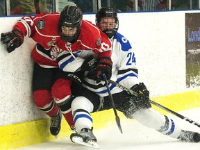 Listowel Cyclones' Bryce McFadden is rubbed out along the boards by Nationals forward Colin Wilson during the first period of Game 5 of the Sutherland Cup semifinal at the Western Fair Sports Centre in London on Wednesday. Derek Ruttan/The London Free Press
