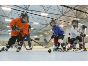 Learn2Roll is teaching kids like Austin Hurd, 7, left, Mason Larocque, 6, and Nathan Vanderlip, 6, to play roller hockey at Argyle Arena. Derek Ruttan/The London Free Press