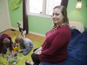 Ward 10 Coun. Virginia Ridley plays with her sons Andrew, 10, left, and Ben, 9 at her home. The request for child care at public meetings first came from Ridley three years ago, and city hall staff gauges the annual cost at between $15,000 and $20,000. (DEREK RUTTAN, The London Free Press)