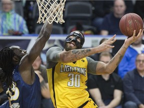 Royce White of the London Lightning shoots while being covered by Ransford Brempong of the St. John's Edge during their NBL playoff game in London on Thursday. Derek Ruttan/The London Free Press