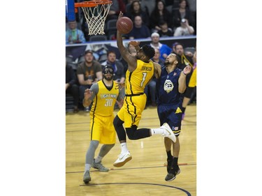 Kyle Johnson of the London Lightning has his shot disrupted by Coron Williams of the St. John's Edge during their NBL playoff game in London on Thursday. No foul was called on the play. Derek Ruttan/The London Free Press