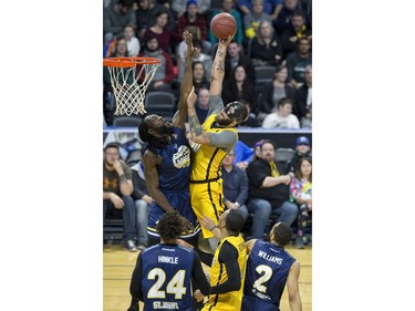 Royce White of the London Lightning shoots while being covered by Ransford Brempong of the St. John's Edge during their NBL playoff game in London on Thursday. Derek Ruttan/The London Free Press