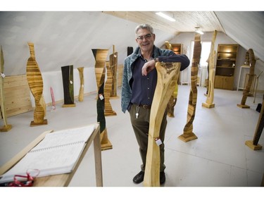 Frank Pereira stands among several of his free form sculptures.  (DEREK RUTTAN, The London Free Press)