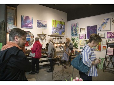 Visitors peruse works of art by Amy Klinkhamer and Claire Cepukas  (DEREK RUTTAN, The London Free Press)