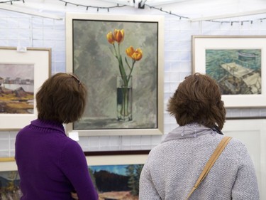 Sisters Sylvia, left, and Belinda Hammoud admire work by Kevin Bice. (DEREK RUTTAN, The London Free Press)