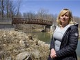 Renee Agathos, pictured in front of one the bridges already installed north of Fanshawe Road, says that a paved pathway will help improve accessibility as well as keep people from wandering off path into environmentally sensitive areas. (MIKE HENSEN, The London Free Press)