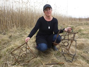 Janine Dupuis, of Poplar Hill, holds up three beaver traps someone had pulled out of the pond in Komoka Provincial Park west of London. Dupuis is disturbed the traps, meant to kill beavers instantly, are being used at all, and that park users weren’t warned about them. (MIKE HENSEN, The London Free Press)