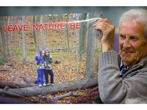 Warren Mackenzie holds up a photo of two children enjoying nature with the slogan "Leave nature be" during a city council debate on the Medway Valley master plan Tuesday.
MIKE HENSEN, The London Free Press