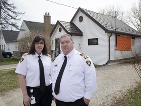 Acting fire chief Lori Hamer and deputy chief Jack Burt say four of the last five fire deaths in London were caused by contraband cigarettes. While not fatal, a fire at 95 St. Julien (behind them) this week was caused by a contraband cigarette. (Derek Ruttan/The London Free Press)