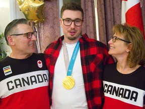 Alex Kopacz, olympic gold medalist in two-man bobsleigh with his parents Joe and Janet at a Polish club. (MIKE HENSEN, The London Free Press)