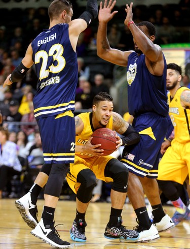 Joel Friesen-Latty of the Lightning grabs a loose ball down low between Carl English and Ryan Reid of the St. John's Edge as the Lightning won 106-101 in a hard fought battle at Budweiser Gardens on Sunday April 29, 2018. The Lightning won the series 4-2 and will now face Halifax for the NBL championship. Mike Hensen/The London Free Press/Postmedia Networki