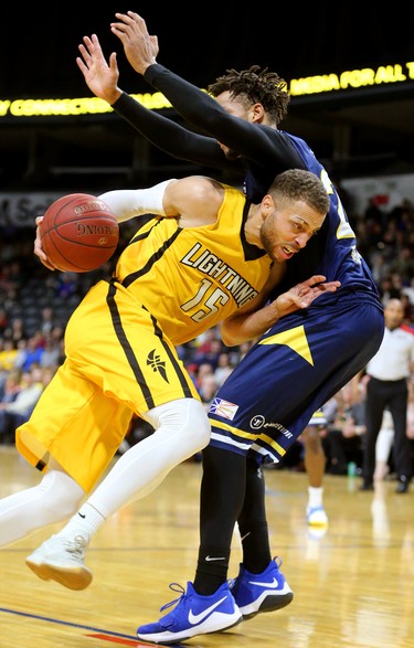 Garrett Williamson of the Lightning drives into the midsection of Charles Hinkle of the St. John's Edge as the Lightning won 106-101 in a hard fought battle at Budweiser Gardens on Sunday April 29, 2018. Williamson led the team with 25 points mostly on hard slashes to the net along with 10 rebounds and 7 assists. The Lightning won the series 4-2 and will now face Halifax for the NBL championship. Mike Hensen/The London Free Press/Postmedia Network