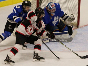 Listowel Cyclones forward Caleb Warren tries to stuff the puck past London goalie David Ovsjannikov as Nationals defenceman Jordan Di Cicco gives chase during the first period of Game 4 of the Sutherland Cup semifinal Tuesday night in Listowel. The Cyclones won 6-1. Cory Smith/The Beacon Herald